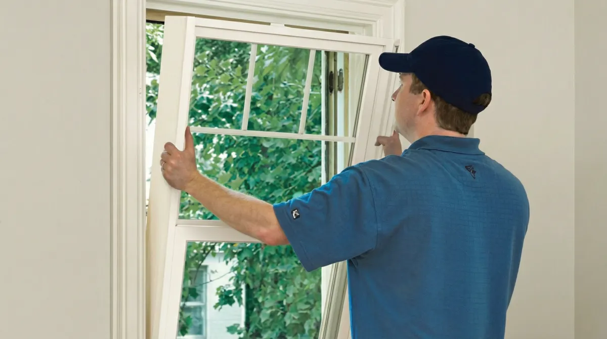 Professional contractors performing a residential window insulation and replacement service in Kansas City, KS
